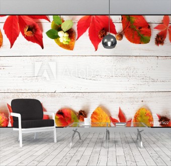 Picture of Bunte Herbstbltter mit Herbstfrchten auf weien Holzbrettern